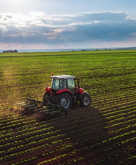 Tractor cultivating fields